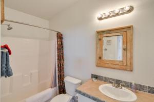 a bathroom with a sink and a toilet and a mirror at Tranquil Cabin Getaway w/ Panoramic Mtn View! in Antero Junction +21 photos