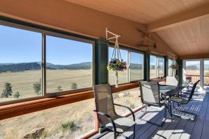 a screened in porch with a table and chairs and windows at Tranquil Cabin Getaway w/ Panoramic Mtn View! in Antero Junction