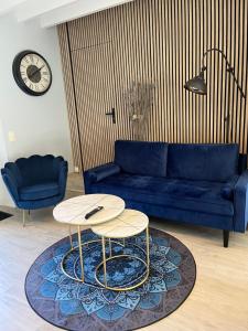 a living room with a blue couch and a table at Villa du Manoir 1685 in Saint Malo