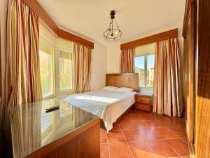 a bedroom with a bed and a window at Luxury 5BR Villa with Sea View & Garden in Einbay in Ain Sokhna