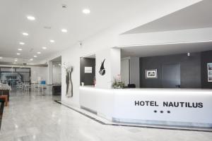 a hotel lobby with a hotel nautilus sign on the wall at Nautilus Hotel in Roses