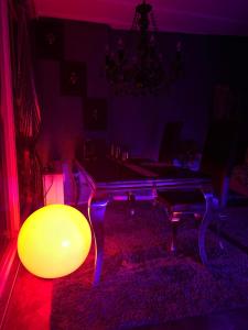 a ping pong table in a living room with a red light at Royal - Sky - Suite in Augsburg