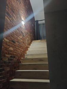 a brick wall and stairs in a room at Apartament z dużym tarasem in Kraków