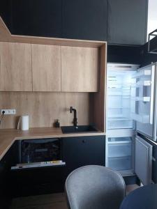 a kitchen with a sink and an empty refrigerator at Apartament z dużym tarasem, bezpłatny parking, AWG APARTMENTS in Kraków