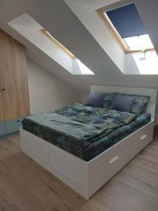 a bedroom with a bed in a attic at Apartament z dużym tarasem in Kraków