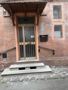 a front door of a brick building with a staircase at Laghetti di Corticella in Bologna