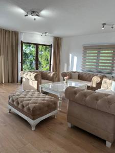 a living room with a couch and a coffee table at Apartmani Dalija in Sarajevo