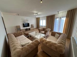 a living room with two couches and a table at Apartmani Dalija in Sarajevo