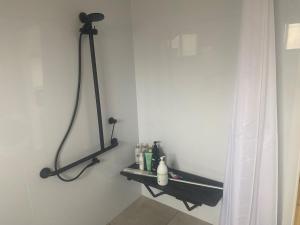 a bathroom with a black shelf on the wall at Hygge Eco Cabins in Jindabyne