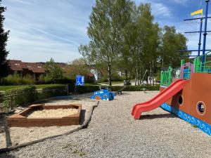 a playground with a slide and a slideintend at SNOW LAKE Lipno in Lipno nad Vltavou