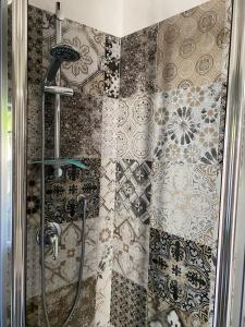 a shower in a bathroom with tiles on the wall at Casa Biscarello - Borgo e Lago in Grotte di Castro