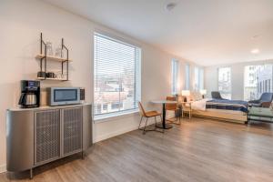 a bedroom with a bed and a tv in a room at Marina Square Suites in Bremerton