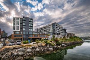 a rendering of a building next to a river at Marina Square Extended Stay Hotel in Bremerton
