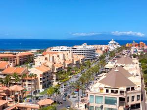 an aerial view of a city with buildings and the ocean at Frontal Ocean View Torres del Sol in Los Cristianos