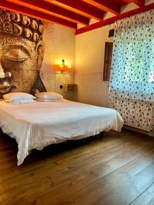 a bedroom with a large bed with a large headboard at Antaviana Cantabria in Cabezón de la Sal