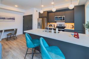 a kitchen with blue chairs and a counter top at NN - The Current 2 - Downtown 1-Bed 1-Bath in Whitehorse