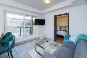 a living room with a couch and a tv and a bed at NN - The Current 2 - Downtown 1-Bed 1-Bath in Whitehorse