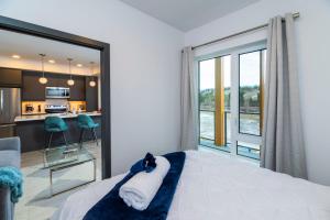 a bedroom with a bed with a cat on top of it at NN - The Current 2 - Downtown 1-Bed 1-Bath in Whitehorse