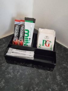 a box of toothbrushes and other products on a table at City Centre Studio 8 with Kitchenette, Free Wifi and Smart TV by Yoko Property in Middlesbrough