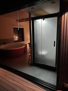a bathroom with a tub and a large glass window at Chado Belgrade in Belgrade