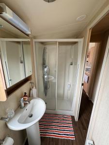 a bathroom with a shower and a white sink at Relax & Dream in Edinburgh