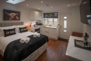 a bedroom with a bed with two towels on it at Heather Nook- luxury studio in Pitlochry in Pitlochry