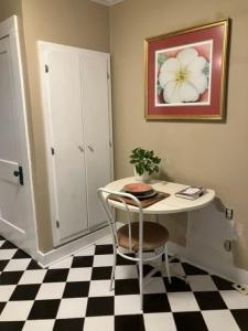 uma mesa e uma cadeira num quarto com piso em xadrez em Cozy Solo Escape em Lafayette