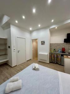 a bedroom with a large bed with two towels on it at Quattro Canti rooms in Palermo +35 photos