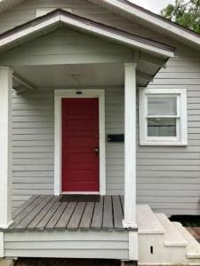a red door on the front of a house at Cozy Solo Escape in Lafayette