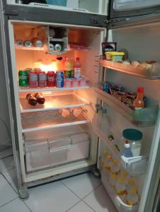 an open refrigerator filled with food and drinks at Perto do Chevrolet Hall in Recife