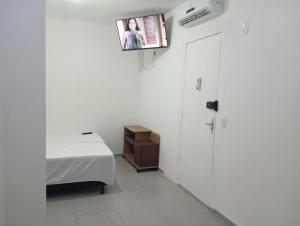 a bedroom with a bed and a tv on the wall at Perto do Chevrolet Hall in Recife