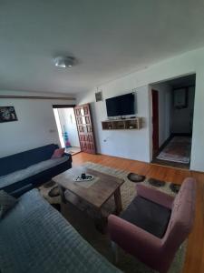 a living room with a couch and a table at Apartman Goga in Pale