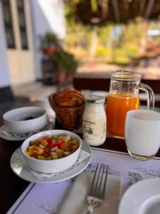 a table with a bowl of food and a bowl of juice at Narbona Wine Lodge in Carmelo