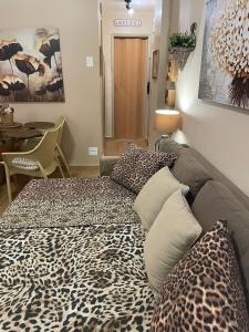 a room with a bed with a leopard print blanket at BeM Ipanema in Rio de Janeiro