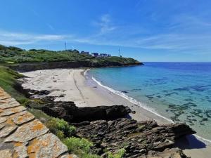 a view of a beach with the ocean at un amour de maison in Le Conquet