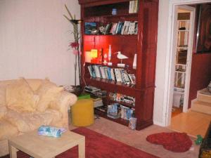 a living room with a couch and a book shelf at un amour de maison in Le Conquet +17 photos
