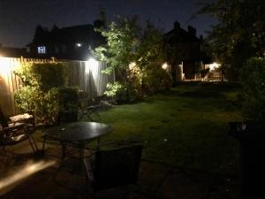 a backyard at night with a table in the yard at Clayton Home in Manchester