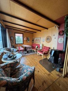 a living room filled with furniture and a table at Lovely retro cabin close to Geysir and Gullfoss in Selfoss