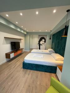 a bedroom with two beds and a television in it at HOME 12 in Librazhd