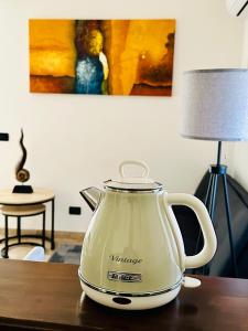 a white tea kettle sitting on top of a table at La casetta di Giulio II in Ostia Antica