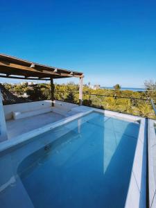 a swimming pool on the roof of a house at Casa Hood By the Sea in Holbox Island