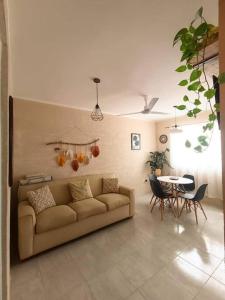 a living room with a couch and a table at Casa Itzé Valladolid in Valladolid