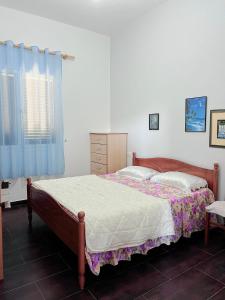 a bedroom with a bed and a dresser at A&A House in Berat