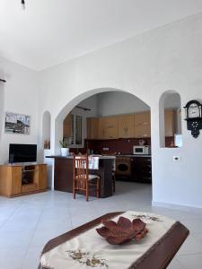 a living room and kitchen with an archway at A&A House in Berat