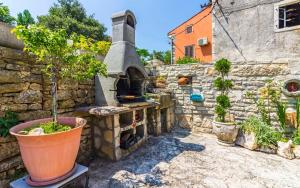 an outdoor oven in a stone wall with potted plants at Ferienhaus für 5 Personen ca 70 qm in Rakalj, Istrien Bucht von Raša in Rakalj +14 photos