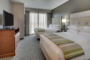 ein Hotelzimmer mit 2 Betten und einem Flachbild-TV in der Unterkunft Drury Plaza Hotel Savannah Pooler in Savannah