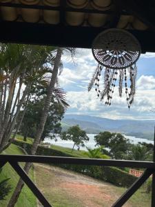 a chandelier hanging from a window with a view at Mirante do Lago in Capitólio