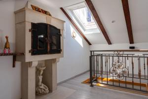 a room with a staircase with a clock on the wall at Apartments Luka, Punta Jurana in Korčula