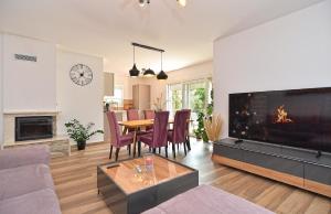 a living room with a table and a large tv at Ferienhaus für 4 Personen ca 74 qm in Medulin, Istrien Südküste von Istrien in Medulin