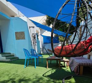 亞喀巴的住宿－Mango Haus，院子内的椅子和秋千
